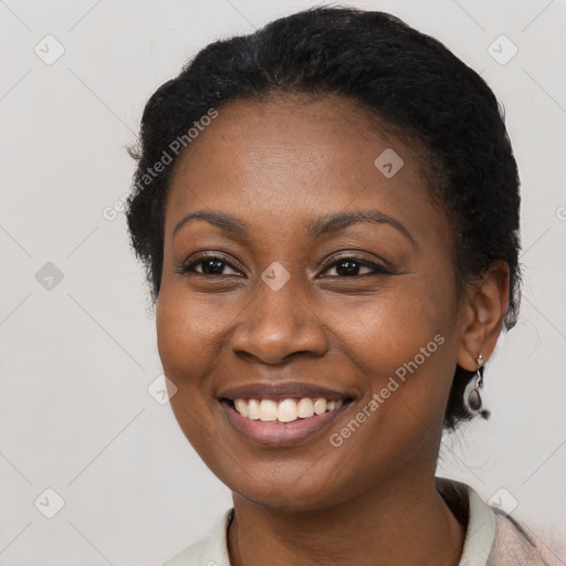 Joyful black young-adult female with short  black hair and brown eyes