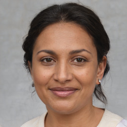 Joyful white adult female with medium  brown hair and brown eyes