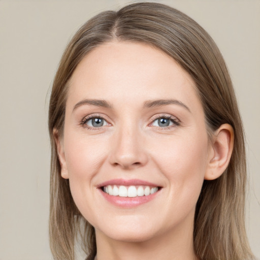 Joyful white young-adult female with long  brown hair and grey eyes