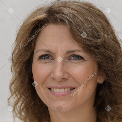 Joyful white adult female with long  brown hair and brown eyes