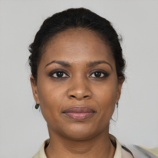 Joyful black young-adult female with short  brown hair and brown eyes