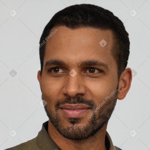 Joyful black young-adult male with short  black hair and brown eyes