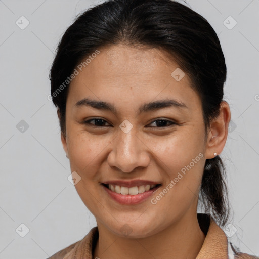 Joyful latino young-adult female with medium  brown hair and brown eyes