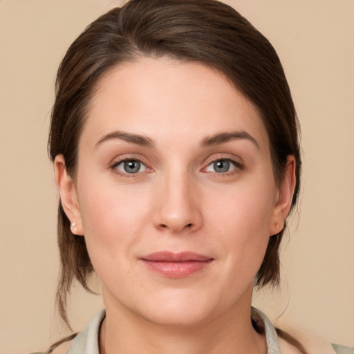 Joyful white young-adult female with medium  brown hair and grey eyes