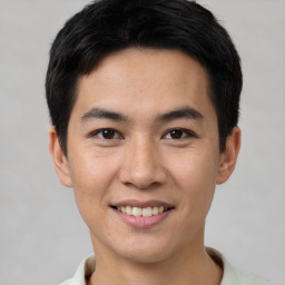 Joyful asian young-adult male with short  black hair and brown eyes