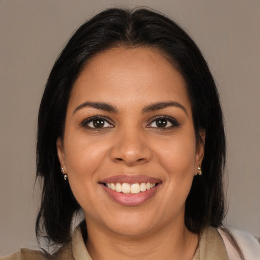 Joyful latino young-adult female with medium  brown hair and brown eyes
