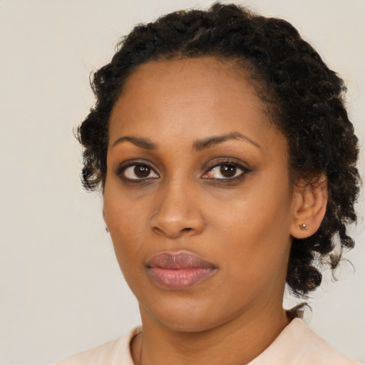 Joyful black young-adult female with medium  brown hair and brown eyes