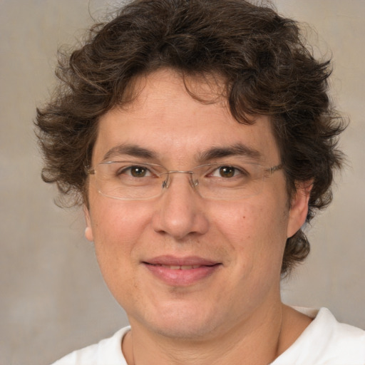 Joyful white adult male with medium  brown hair and brown eyes