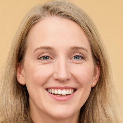 Joyful white young-adult female with long  brown hair and blue eyes