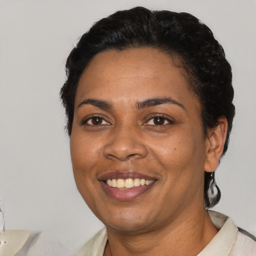 Joyful black young-adult female with short  black hair and brown eyes
