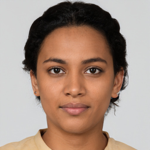Joyful latino young-adult female with short  black hair and brown eyes