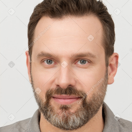 Joyful white adult male with short  brown hair and grey eyes