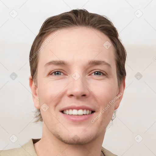 Joyful white young-adult male with short  brown hair and grey eyes