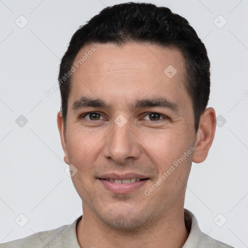 Joyful white young-adult male with short  black hair and brown eyes