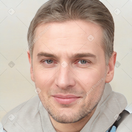 Joyful white adult male with short  brown hair and brown eyes