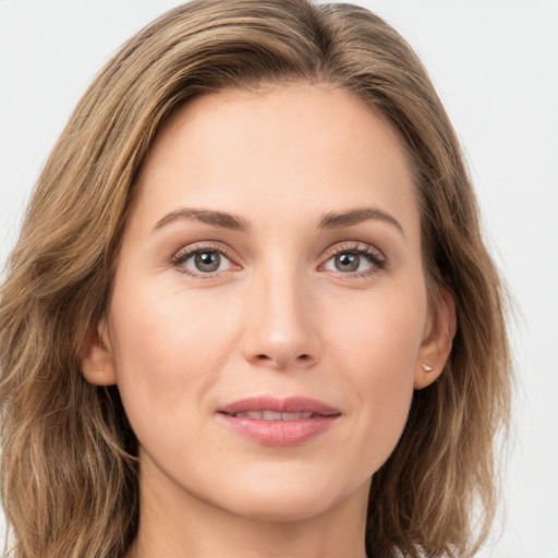 Joyful white young-adult female with long  brown hair and green eyes