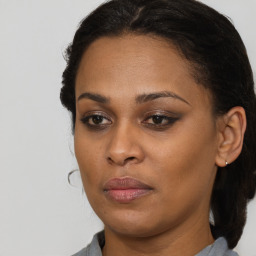 Joyful black young-adult female with medium  brown hair and brown eyes