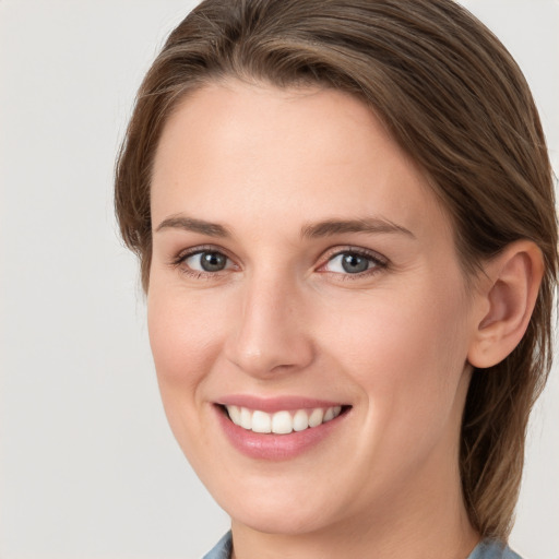 Joyful white young-adult female with long  brown hair and grey eyes