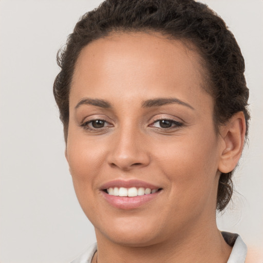 Joyful white young-adult female with short  brown hair and brown eyes