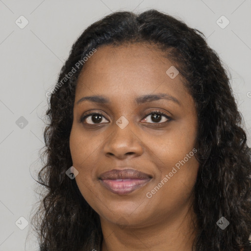 Joyful black young-adult female with long  brown hair and brown eyes