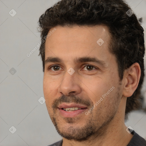 Joyful white adult male with short  black hair and brown eyes