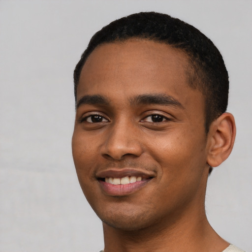 Joyful black young-adult male with short  black hair and brown eyes