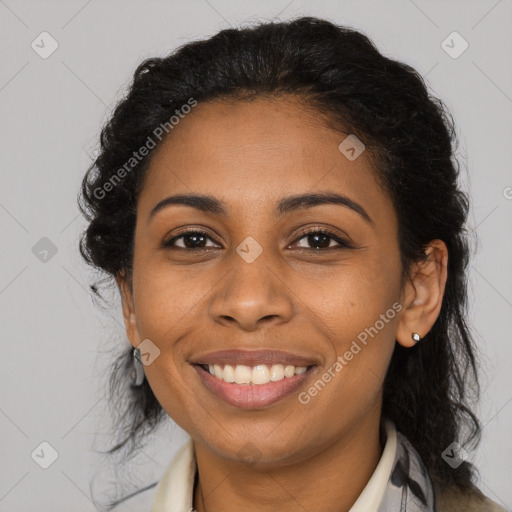 Joyful black young-adult female with long  brown hair and brown eyes