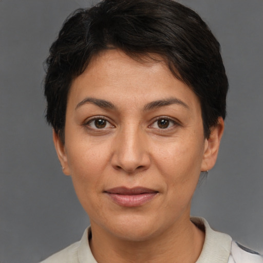 Joyful white adult female with short  brown hair and brown eyes