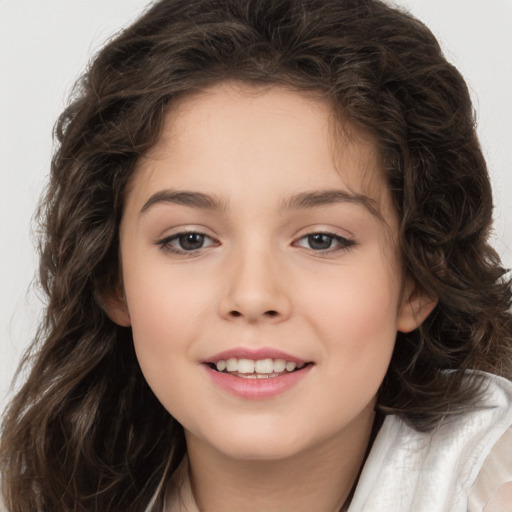 Joyful white child female with long  brown hair and brown eyes