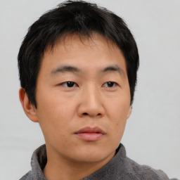 Neutral asian young-adult male with short  brown hair and brown eyes