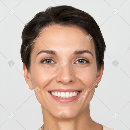 Joyful white young-adult female with short  brown hair and grey eyes