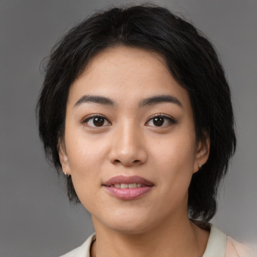 Joyful asian young-adult female with medium  black hair and brown eyes
