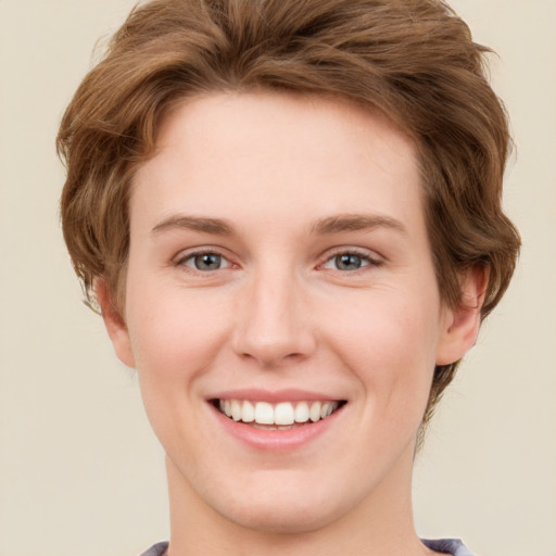 Joyful white young-adult female with short  brown hair and green eyes