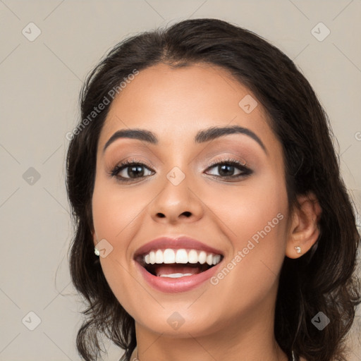 Joyful white young-adult female with medium  black hair and brown eyes