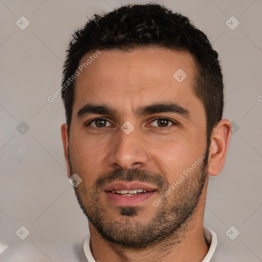 Joyful white young-adult male with short  black hair and brown eyes