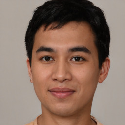 Joyful asian young-adult male with short  black hair and brown eyes