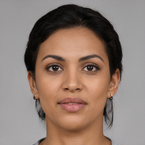 Joyful latino young-adult female with medium  black hair and brown eyes