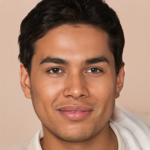 Joyful latino young-adult male with short  brown hair and brown eyes