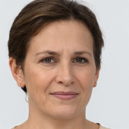 Joyful white adult female with short  brown hair and brown eyes