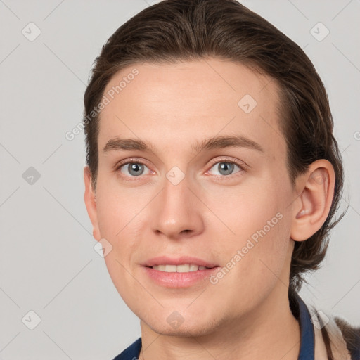 Joyful white young-adult female with short  brown hair and grey eyes