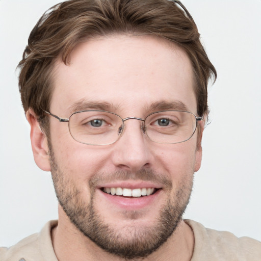 Joyful white adult male with short  brown hair and grey eyes