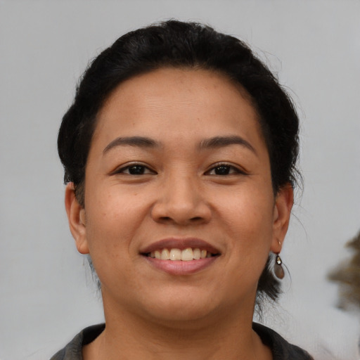 Joyful latino young-adult female with short  brown hair and brown eyes