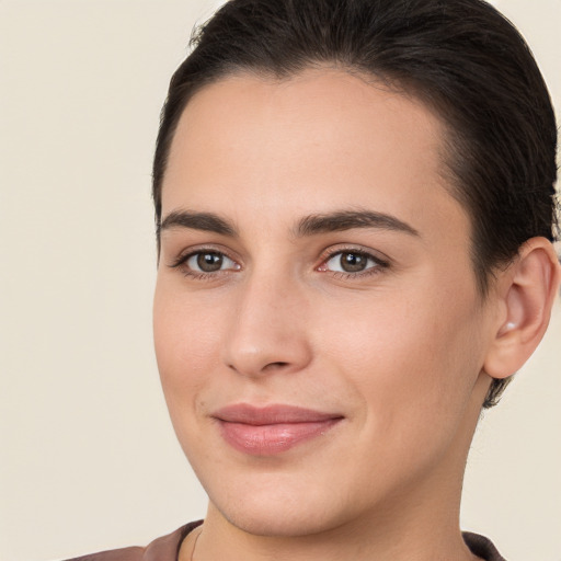 Joyful white young-adult female with short  brown hair and brown eyes