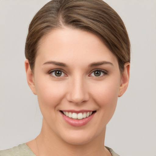 Joyful white young-adult female with short  brown hair and brown eyes