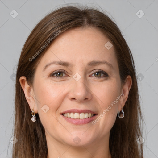 Joyful white adult female with long  brown hair and grey eyes