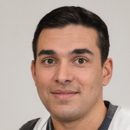 Joyful white young-adult male with short  black hair and brown eyes