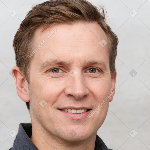 Joyful white adult male with short  brown hair and grey eyes