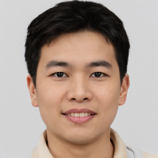 Joyful asian young-adult male with short  brown hair and brown eyes