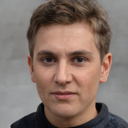 Joyful white adult male with short  brown hair and grey eyes