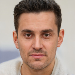 Joyful white adult male with short  brown hair and brown eyes